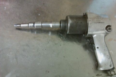 2005 GMC Yukon - This air impact wrench is a tool used for automotive repair, likely for transmission work.