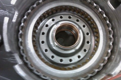 2005 GMC Yukon - Close-up of a transmission clutch pack, showing intricate metal components and a central bearing.