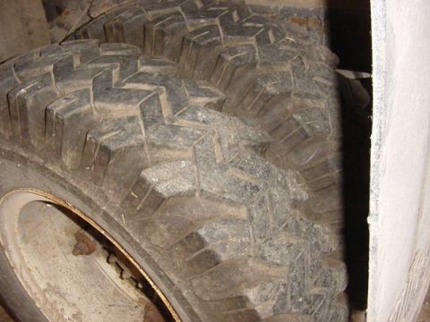 1992 Ford Bronco - These large off-road tires feature a deep, aggressive tread pattern, suggesting they are designed for challenging terrain.