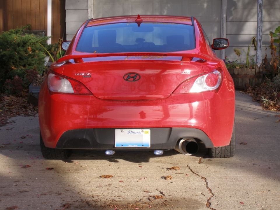 Red Hyundai Genesis coupe rear with spoiler and dual exhaust