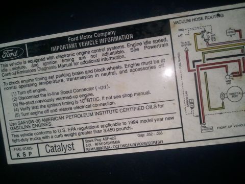 1994 Ford Bronco - Ford emissions information label with a color-coded vacuum hose routing diagram for a 5.0L engine.