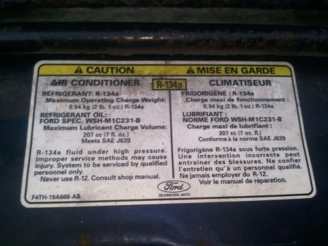 1994 Ford Bronco - Ford A/C system spec label listing R-134a refrigerant charge weight and lubricant specifications.