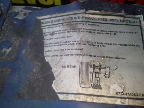 1994 Ford Bronco - Vehicle jacking instructions label with numbered safety steps and a rear-axle jack placement figure.