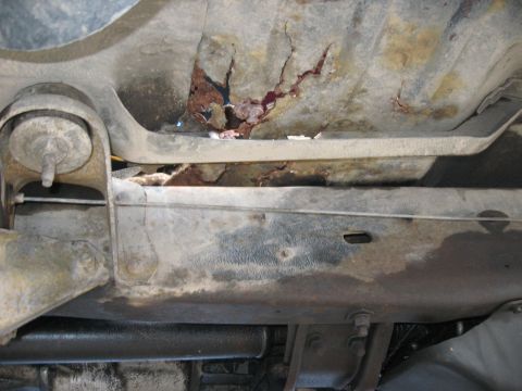 1981 Ford Bronco - Severe rust and corrosion are visible on the vehicle's undercarriage frame.