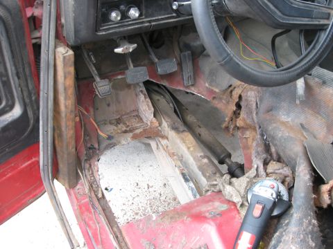 1981 Ford Bronco - The interior floor of a 1981 Ford Bronco shows significant rust damage and is being prepped for repair.