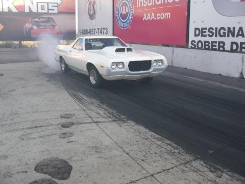 1972 Ford Ranchero - White 1972 Ford Ranchero performs a burnout on a drag strip, emitting smoke from its tires.