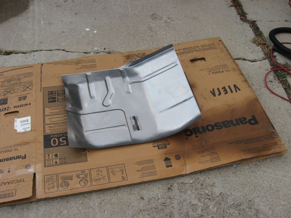 metal floor pan part sitting on cardboard