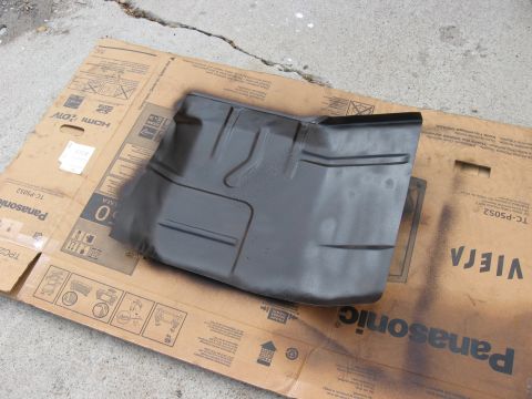 1981 Ford Bronco - Car floor pan part resting on cardboard packaging.