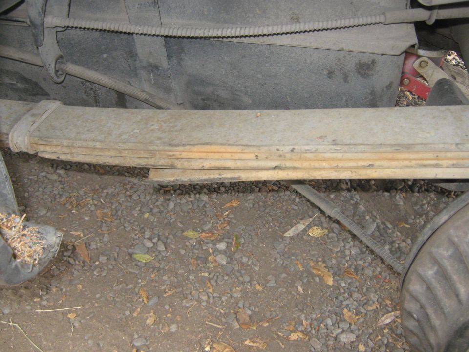Leaf spring and fuel tank underside of a vehicle