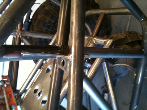 1966 Ford Bronco - Close-up view of a custom roll cage with a tire in the background.
