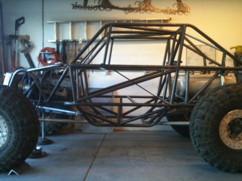 1966 Ford Bronco - A custom-built buggy with a prominent roll cage and large tires is shown during its construction phase.