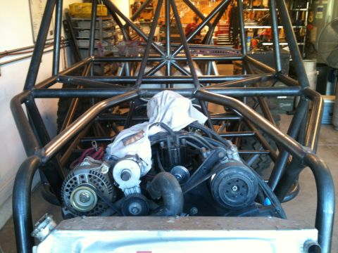 1966 Ford Bronco - Custom buggy frame with engine and alternator visible, covered with a cloth.
