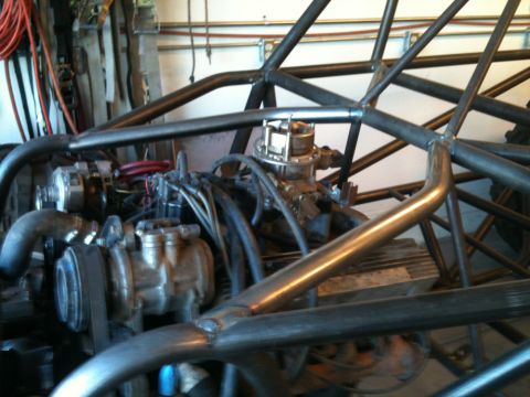 1966 Ford Bronco - Close-up view of an engine and custom roll cage structure.