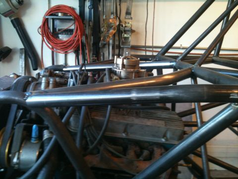 1966 Ford Bronco - Close-up view of an engine and custom roll cage structure.