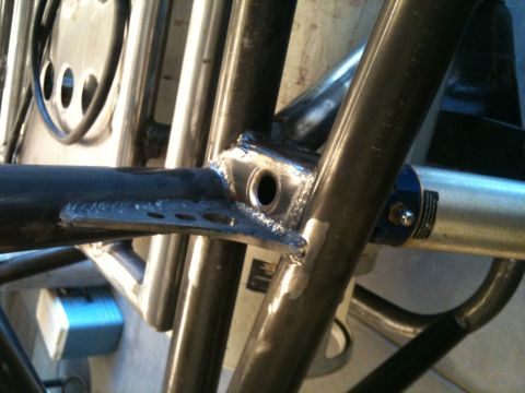 1966 Ford Bronco - Detail shot of custom roll cage tubing and a shock absorber assembly.