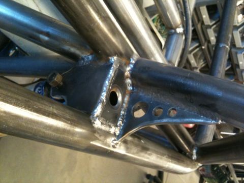 1966 Ford Bronco - Detail of a custom-built roll cage and suspension mounting point, welded steel tubing and brackets.