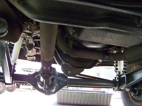 1989 Ford Bronco - Undercarriage view showing the rear axle, driveshaft, and suspension components.