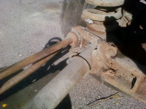 1989 Ford Bronco - Close-up of heavily rusted vehicle suspension parts, likely from an older truck or SUV.