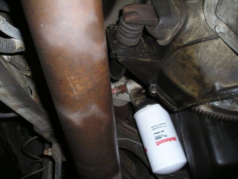 1997 Ford F-250 - Underside view of a driveshaft and a Motorcraft oil filter.