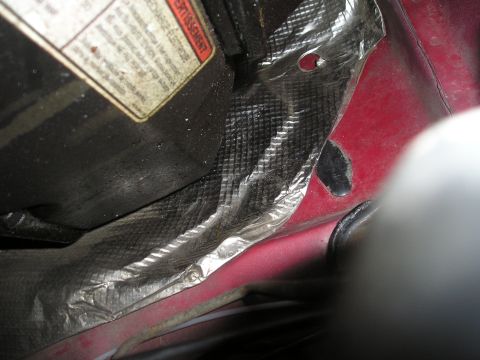 1997 Ford F-250 - Close-up of engine bay insulation and a warning label on a 1997 Ford F-250.