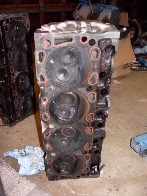 1980 Ford Bronco - Engine cylinder heads are shown, with one unit in the foreground and another partially visible to the left.