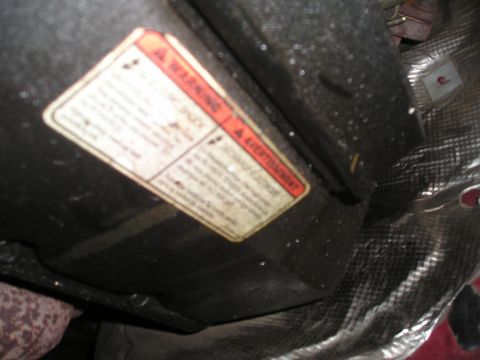1997 Ford F-250 - A warning label with text in English and French is affixed to a dark component, possibly part of a vehicle's engine or exhaust system.