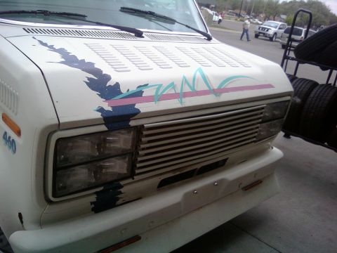2000 Mercury Grand Marquis - White van with custom graphics on the hood and "460" on the fender.