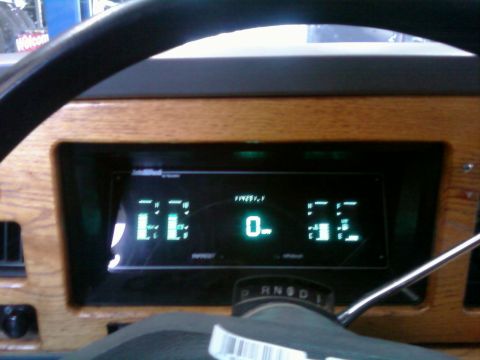2000 Mercury Grand Marquis - The digital dashboard displays 'EE', '0', and '52' with wood grain accents.