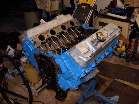 1980 Ford Bronco - Engine assembly on a stand, likely undergoing reassembly or repair.