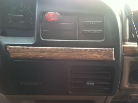 1994 Ford Bronco - Interior view of a 1994 Ford Bronco dashboard, showing the instrument cluster and control buttons.
