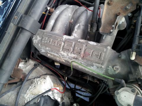 1995 Ford Bronco - Close-up of the engine intake manifold, clearly marked '5.0 HO', consistent with a 1995 Ford Bronco.