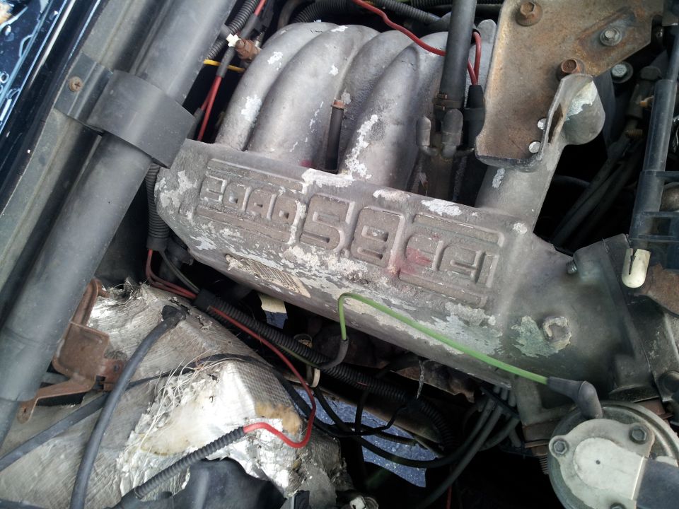 Dirty engine intake manifold cast with Ford 5.0L lettering