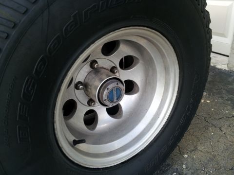 1995 Ford Bronco - BFGoodrich tire on a 1995 Ford Bronco wheel with a blue hub cap.
