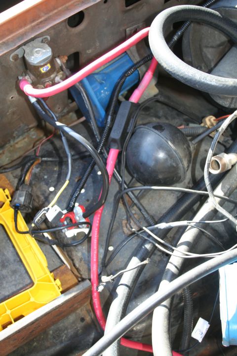1982 Ford Bronco - Close-up view of the engine bay wiring and electrical components, including a capacitor and battery connections.