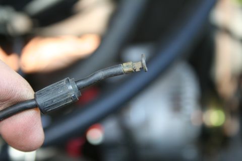 1982 Ford Bronco - Close-up of a detached electrical connector with a hand holding the cable.