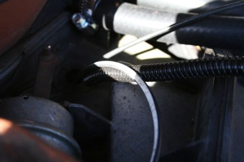 1982 Ford Bronco - Corrugated loom protecting wires in an engine bay, likely part of the charging system.