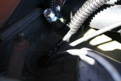 1982 Ford Bronco - Detail of a vehicle's engine bay wiring, showing a clamped wire bundle.