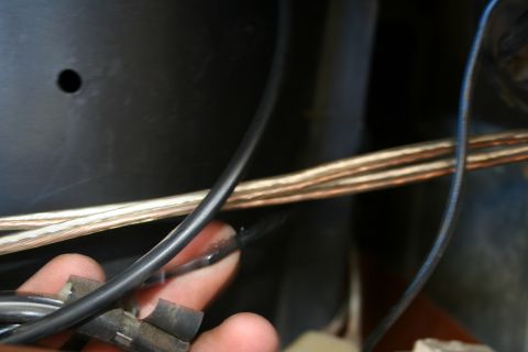 1982 Ford Bronco - Close-up view of a hand manipulating electrical wiring and connectors.