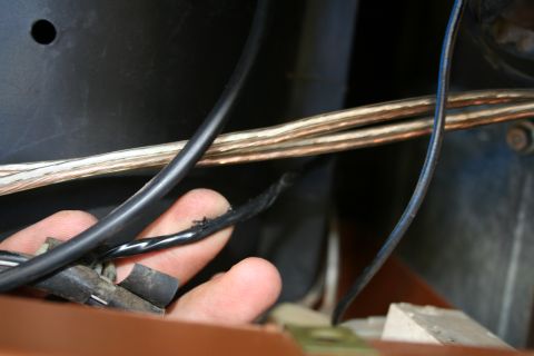 1982 Ford Bronco - Close-up of frayed electrical wiring within a vehicle's engine bay or dashboard area.