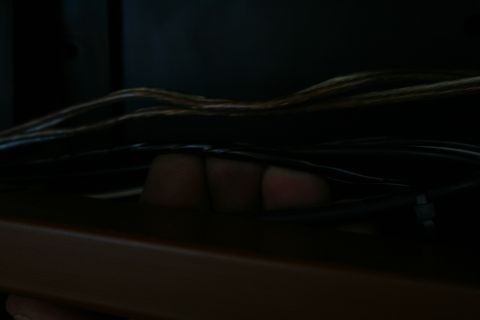 1982 Ford Bronco - Fingers are visible amongst a tangle of electrical wires, suggesting work on a vehicle's wiring system.