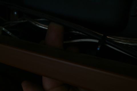 1982 Ford Bronco - A finger points to a section of wiring harness, likely related to the charging system.