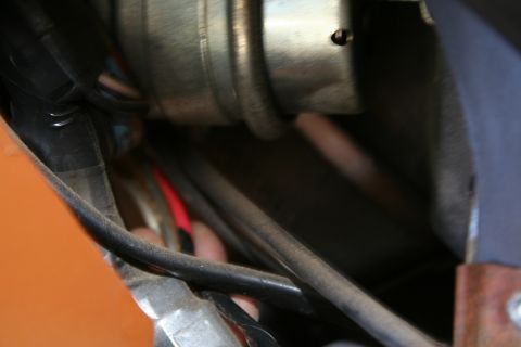 1982 Ford Bronco - A close-up view shows an orange panel and a complex wiring harness near a metallic component.