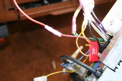 1982 Ford Bronco - Wiring harness for a car stereo, an ACC label and various colored wires connected to a unit.