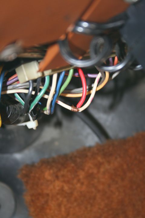 1982 Ford Bronco - A tangle of wires, some frayed, are visible within the vehicle's interior.