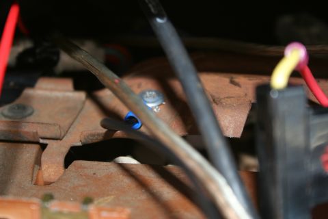 1982 Ford Bronco - Focus on the wiring and rusty components within the vehicle's engine bay.