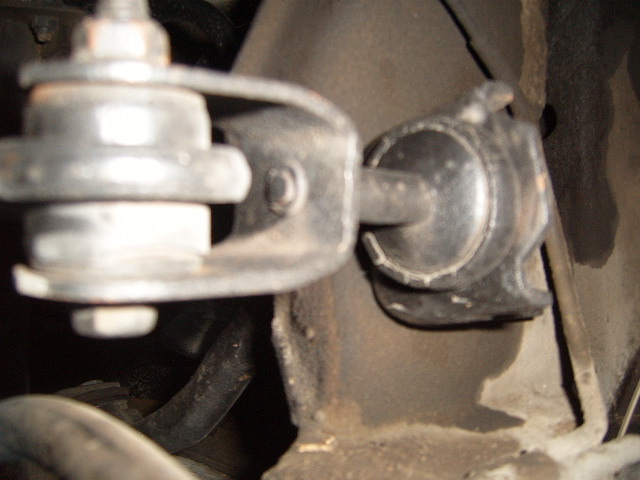 Close-up of a vehicle suspension component, possibly a sway bar link