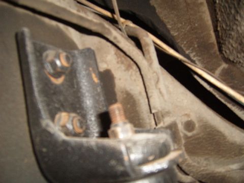 1973 Ford Ranchero - Undercarriage bracket with visible bolts and rust.