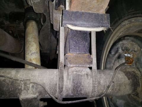 1995 Ford Bronco - Close-up view of the rear suspension components of a vehicle, with a watermark from Supermotors.net visible.