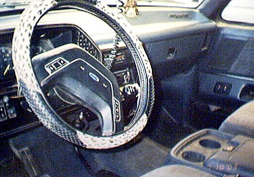 Ford truck interior with white laced steering wheel cover and column shifter