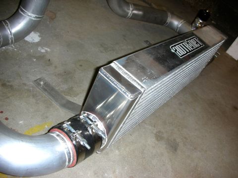 2004 Ford Crown Victoria - An ADTR supercharger intercooler is shown with aluminum piping and clamps, suggesting an aftermarket performance upgrade.